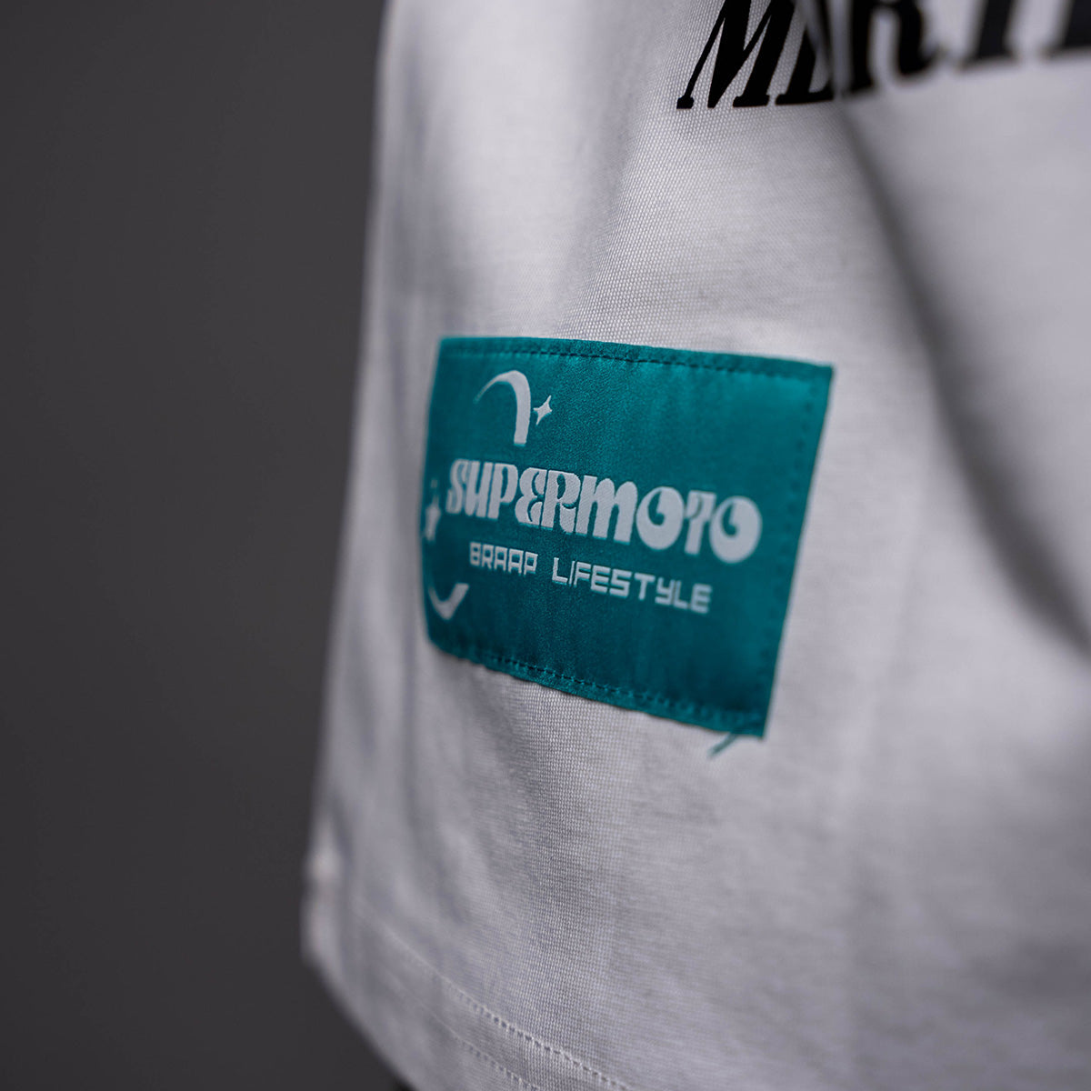 Turquoise 'Supermoto Road Lifestyle' patch on white EWK Signature T-shirt